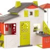 Spielhaus Neo Friends House DeLuxe Smoby Mit Zwei Spielküchen Und Tischen Mit Einem Sonnenschirm Mit Umzäunung